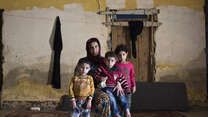 A Syrian family living as refugees in an abandoned building in Lebanon. 