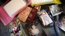 A collection of a refugees belongings including baby photographs 