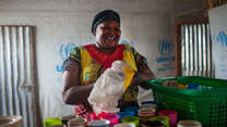 Zulu Likichio dries dishes at her restaurant in Bidi Bidi, Uganda