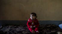 A toddler at home in east Mosul