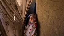 A young girl at the entrance to a classroom in eastern Kabul