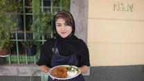 Hafeza stands outside NAN restaurant holding her freshly cooked Afghan Bolani
