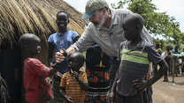 Mandy Patinkin with children at a refugee settlement in Uganda