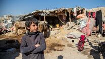 A young boy standing in Ghaibi Bala camp in Kabul, Afghanistan