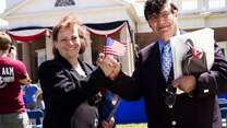 A refugee couple hold a U.S. flag at their naturalization ceremony in Charlottesville, VA