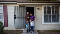 Congolese refugee family outside home in Arizona