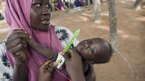Mother holds baby while undergoing medical tests