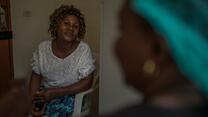 An Ebola survivor in Congo receives mental health support from International Rescue Committee staff member seated across from her.