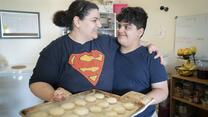 10-year-old Yousif holds a plate of freshly baked shakar lama (caradmom) cookies with his mom, Taghreed