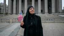 Maha, 66, a former Iraqi refugee, stands outside the federal building in lower Manhattan, after she passes her U.S. citizenship exam.