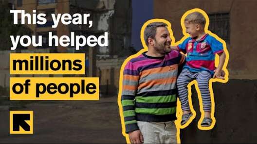 Text reading, "This year you helped millions of people". A father and son stand in the forefront of a photo.