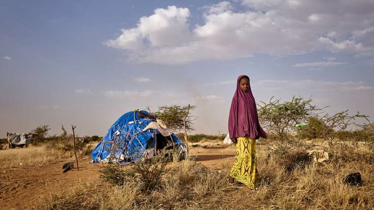 A young girl walks away from a temporary shelter in Mali.