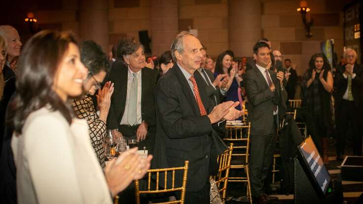 People standing and clapping