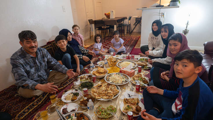 The family sit around their prepared Iftar meal.