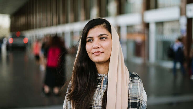 Maryam faces the camera, smiling.