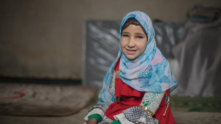 Sara smiles for the camera and smiles for the camera in her house