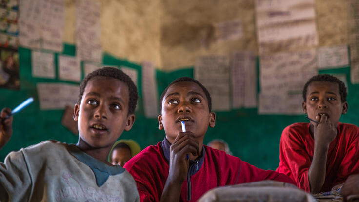 Three children thinking.