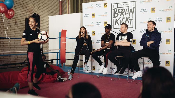 Children taking pictures with members of the German footballers team.